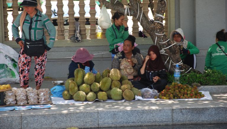 Durian and rambutan sellers set up on the street near the durian roundabout in Kampot