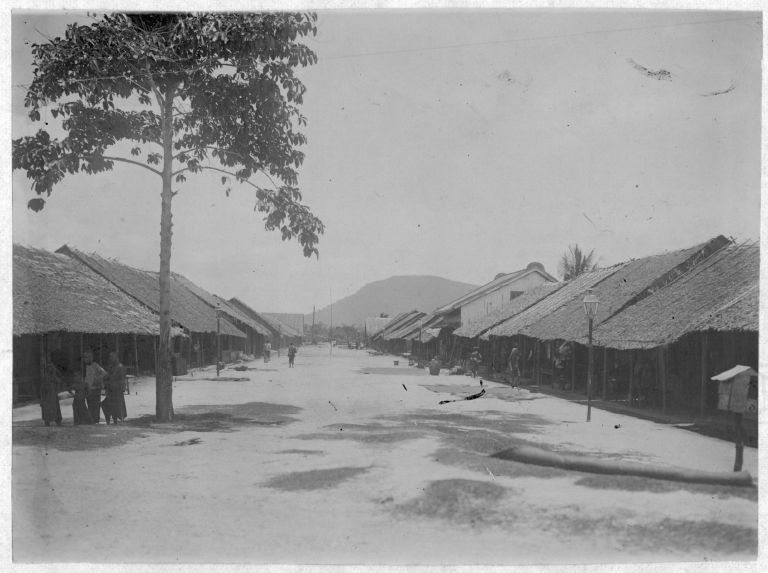 A street in early colonial Kampot, the Elephant Mountains rising on the horizon.