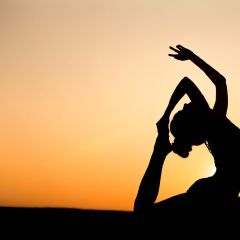 Silhouette of a yoga pose at sunset