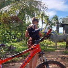 Cyclists stopped at a village house on a countryside tour